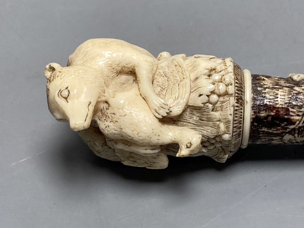 A Dieppe carved ivory pipe tamper, length 11cm